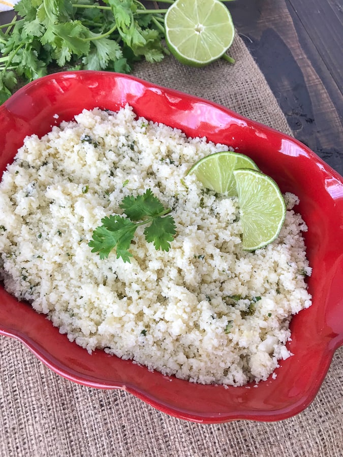 Garlic and Lime Cauliflower Rice - a delicious low-carb alternative to regular rice. This is a simple and easy-to-make side dish that uses fresh, healthy ingredients. I promise that you won't miss the rice too much! It is also great if you're looking for a comforting carb-filled meal, but without the hefty carb load! #cauliflower #cauliflowerrice #vegetables #sidedish #mexican #healthy | www.withpeanutbutterontop.com