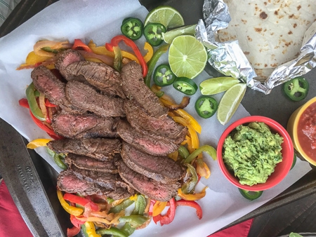 The Best and Easiest Garlic Lime Steak Fajitas -  these steak fajitas are easier to make than you think and absolutely delicious! Tender marinated flat iron steak served with sautéed bell peppers, onions, and a creamy Cilantro Lime Avocado Mash. #steak #dinner #easy #steakfajitas #fajitas #mexican #onepan | www.withpeanutbutterontop.com