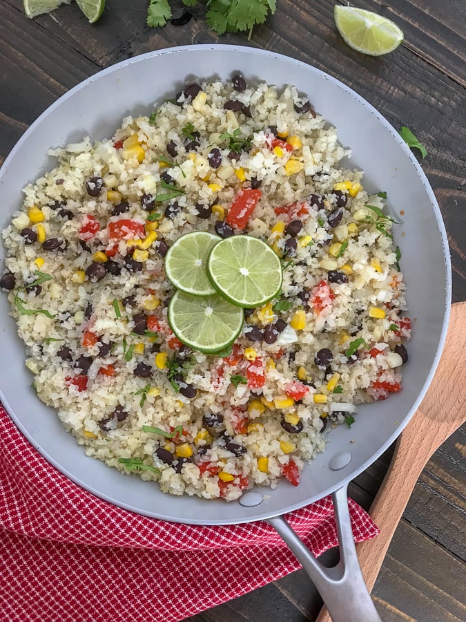 Cilantro Lime Black Bean and Corn Cauliflower Rice - an incredibly easy and flavorful side dish that is packed full of veggies and can be on your plate in 15 minutes or less! 115 calories per serving! #healthy #cauliflowerrice #glutenfree #vegan #healthy | https://withpeanutbutterontop.com