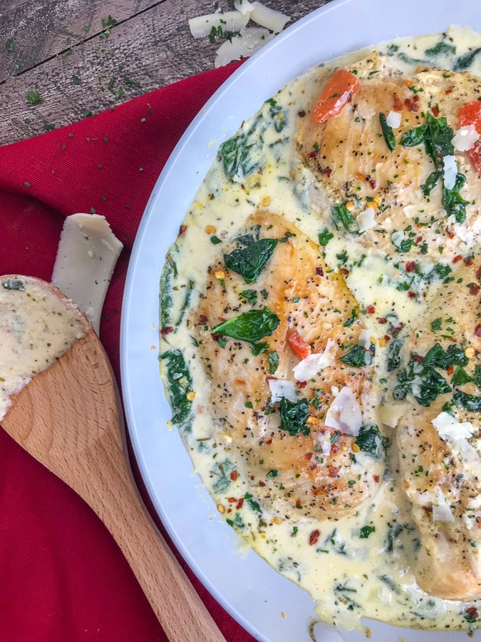 Creamy Garlic Parmesan and Roasted Red Pepper Chicken - a one-pan, easy-to-make comforting recipe that will give you all the warm fuzzy, content feelings. The chicken is pan-seared and combined in a delicious, creamy sauce combining all the perfect flavors of parmesan cheese, spinach, roasted red peppers, and garlic.