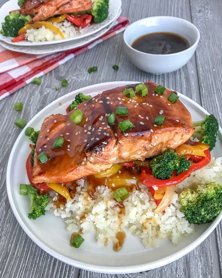 Honey Teriyaki Salmon with Cauliflower Rice - a deliciously sticky, sweet and savory dish that can be on your table in under 30 minutes. Skip the high-calorie, high-carb takeout and try this healthier, low-carb rendition! #healthy #takeout #teriyaki #salmon #cauliflowerrice | https://withpeanutbutterontop.com