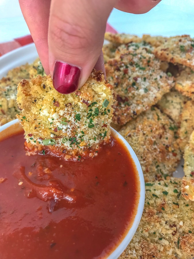 Baked Parmesan Crusted Ravioli Bites - the perfect game-day gathering or party finger food that you can enjoy without the guilt of traditional fried ravioli! Super crispy on the outside, yet cheesy on the inside. Easy to make! #ravioli #appetizers #baked #gameday | https://withpeanutbutterontop.com