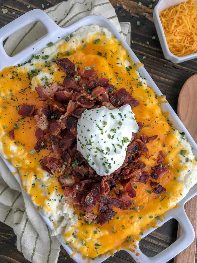 Creamy Garlic Butter Loaded Mashed Cauliflower - the ultimate in low-carb comfort food! So easy to make, full of flavor, and so delicious you won't even notice it's not regular mashed potatoes! #easy #sidedishes #lowcarb #cauliflower #mashedcauliflower | https://withpeanutbutterontop.com