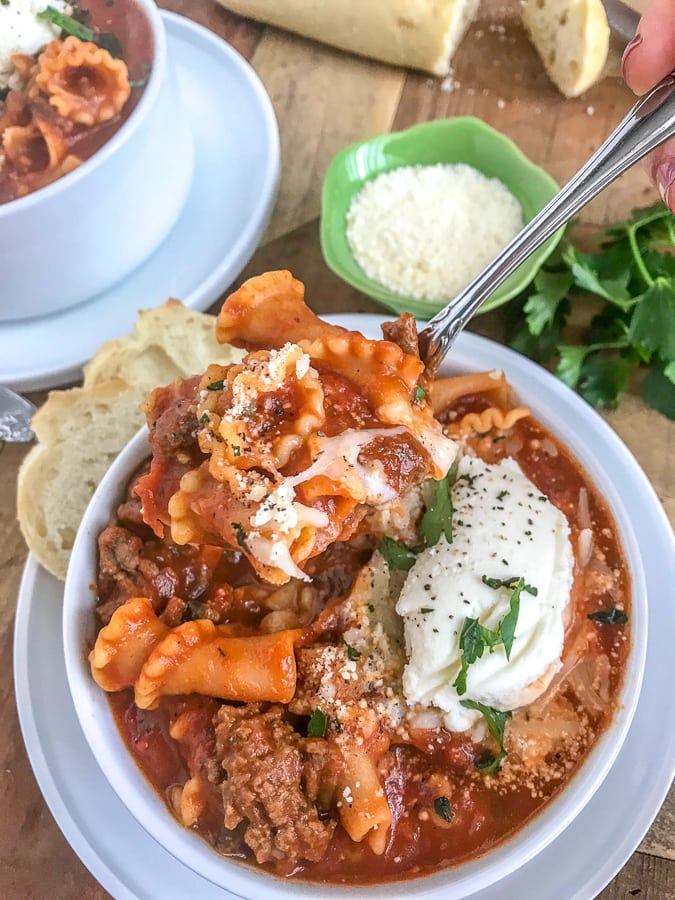 Easy One Pot Lasagna Soup - a delightful twist on a comforting dish. Guaranteed to become a family favorite as it tastes just like lasagna, but requires no layering or baking. Just ONE pot! Bursting with flavor, full of noodles and cheese, and Italian spices. #lasagna #lasagnasoup #soup #onepot #onepotmeals | https://withpeanutbutterontop.com