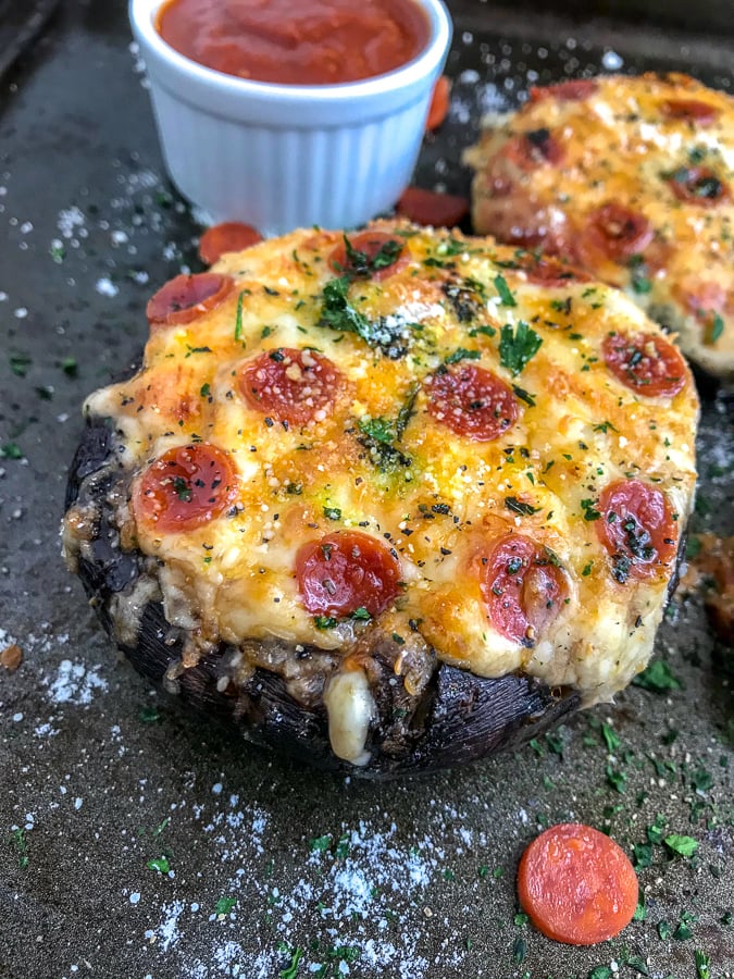 Spinach Dip Stuffed Portobello Mushrooms - a delicious, guilt-free, low-carb combination of spinach dip and pizza! Easy to make and sure to be a hit with your family and friends! #easyappetiziers #appetizer #lowcarb #stuffedmushrooms | https://withpeanutbutterontop.com