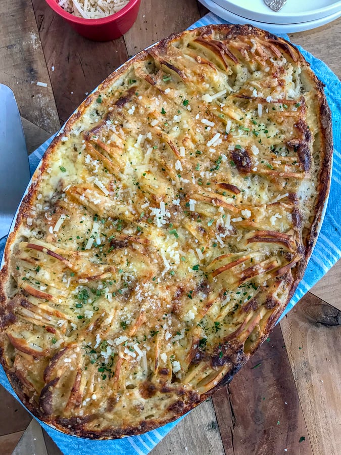 Cheesy Hasselback Potatoes - perfect for those who love crispy, cheesy potatoes! Golden and crispy potatoes that are easy to make, full of flavor, and a wonderful side dish to any meal. #potatoes #sidedish #baked #cheesyhasselback | https://withpeanutbutterontop.com