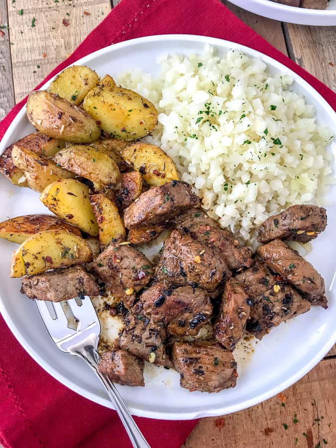 Garlic Butter Steak and Potatoes - an easy one-pan recipe that is bursting full of flavor! Crispy on the outside, fork-tender on the inside, potatoes and the most juicy steak. Both are cooked to perfection in a garlic and herb-butter sauce. Ready in 30 minutes or less! | https://withpeanutbutterontop.com