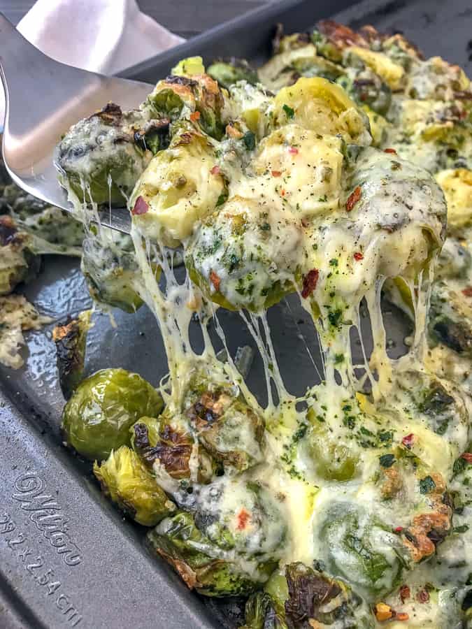 Cheesy Pepper Jack Roasted Brussels Sprouts with freshly grated pepper jack cheese make for the best side dish! They are very easy to make and come together on on sheet pan! Tender, crisp brussels sprouts are roasted with garlic, pepper jack cheese, and onions. #sheetpan #sheetpanrecipes #brusselssprouts #cheesybrusselssprouts | https://withpeanutbutterontop.com